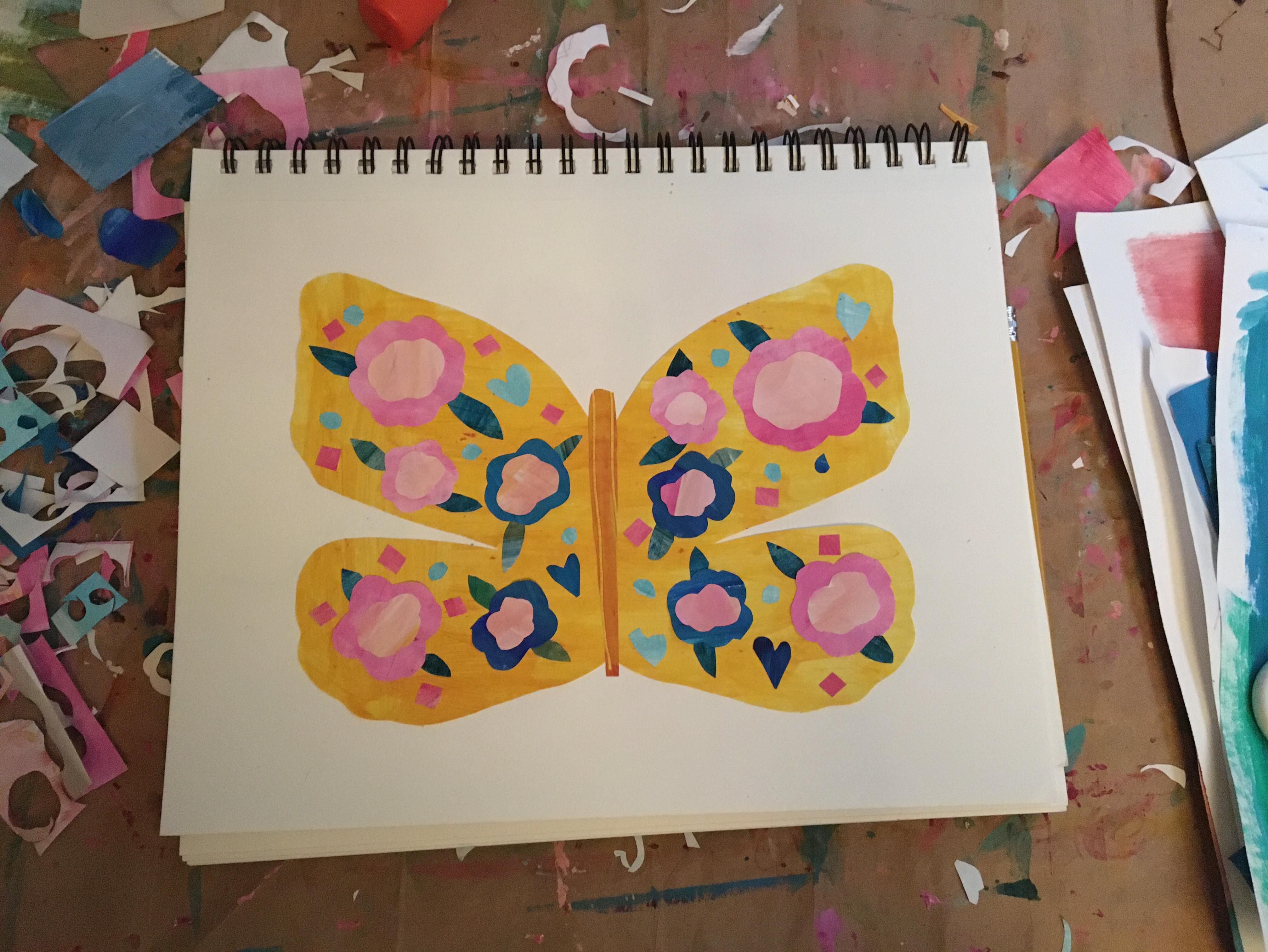 a yellow butterfly filled with pink and blue flowers