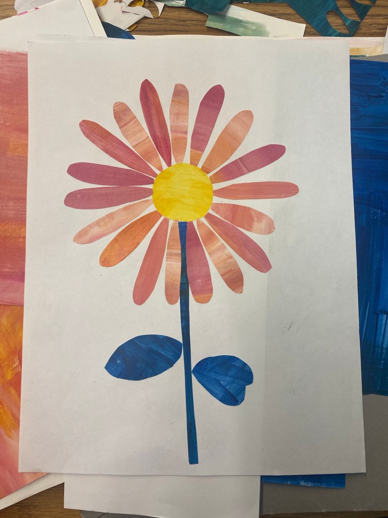 a yellow center with shades of pink and orange petals flower