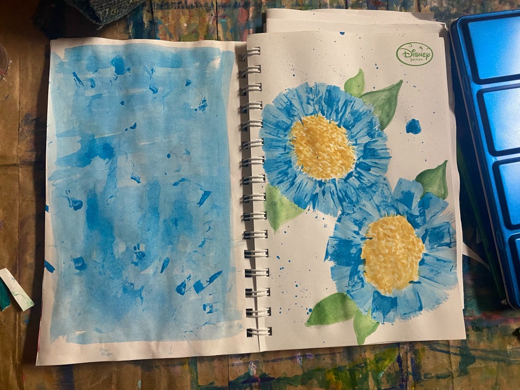 two blue flowers made with a paper roll
