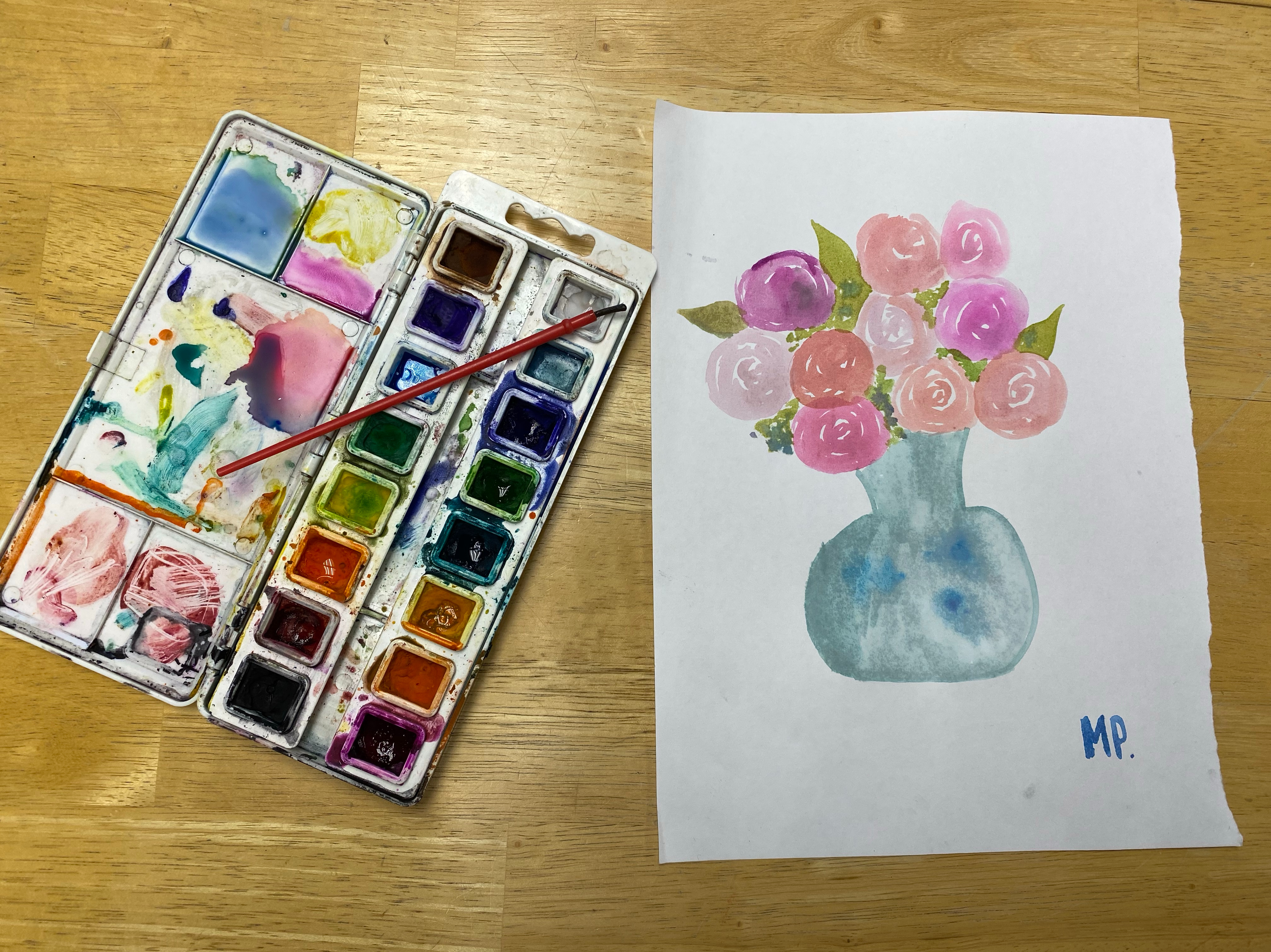 ten pink roses in a blue vase