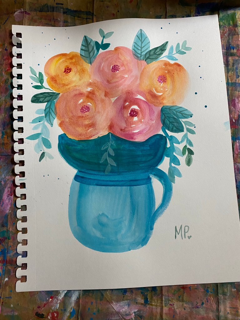 pink and oragne roses in a blue mug vase