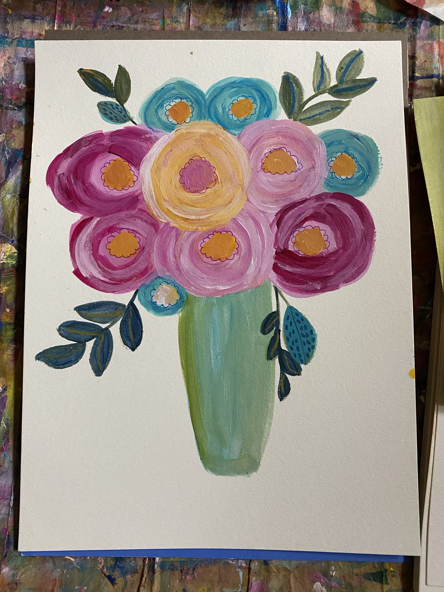 blue vase with pinkm blue and yellow abstract flowers