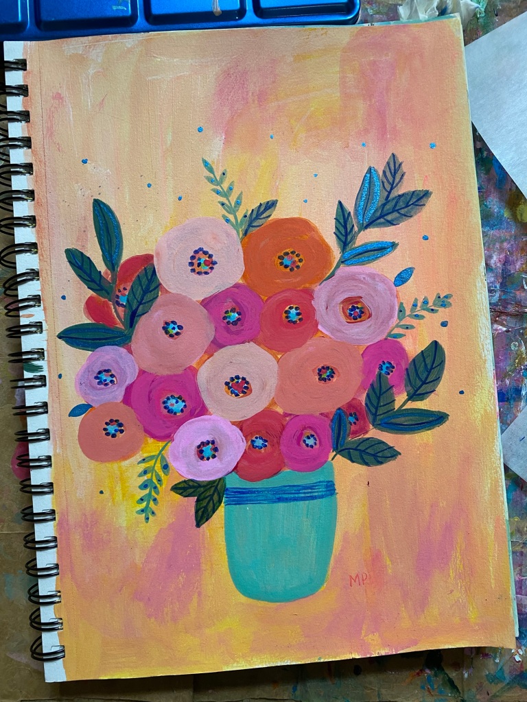 pink and orange flowers in a blue vase