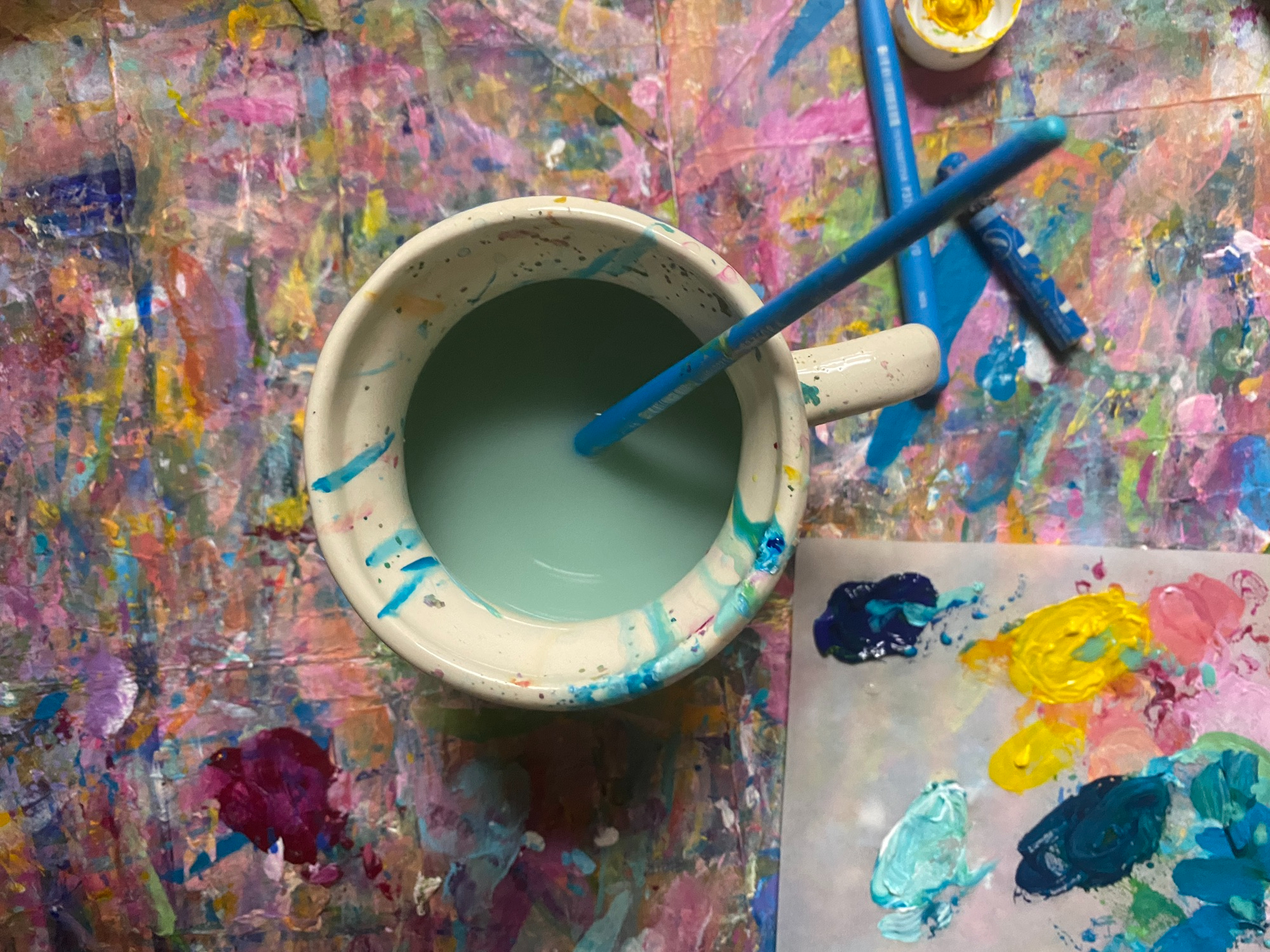 sage green acrylic paint colors and a water cup