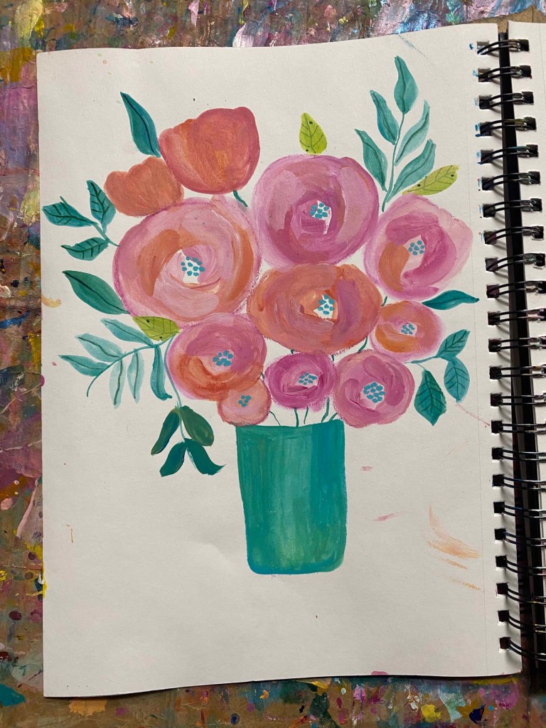 a bouquet of pink and orange flowers in a blue base