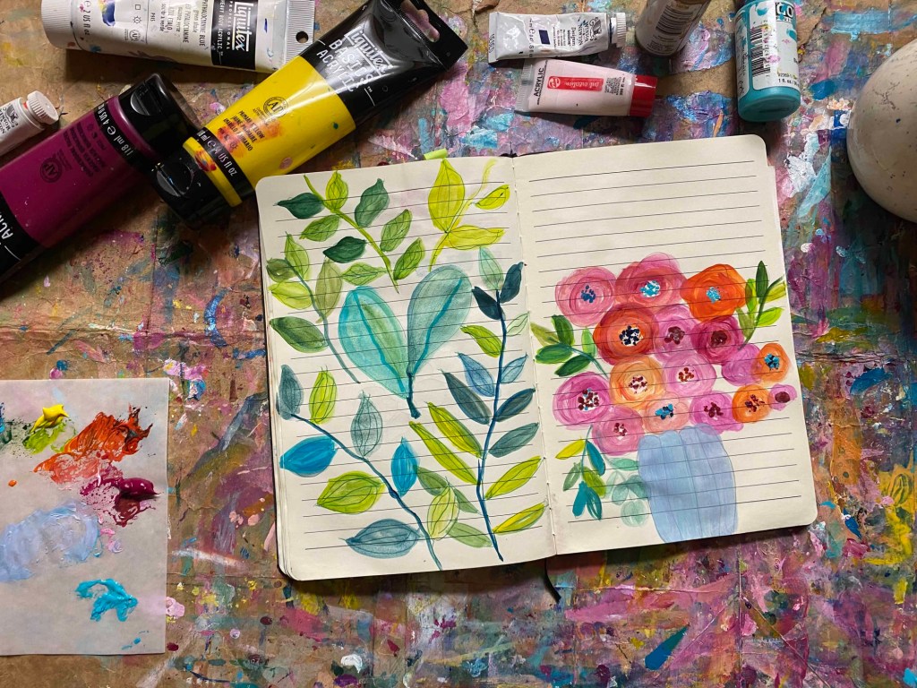 An open journal book with leave and flower doodles